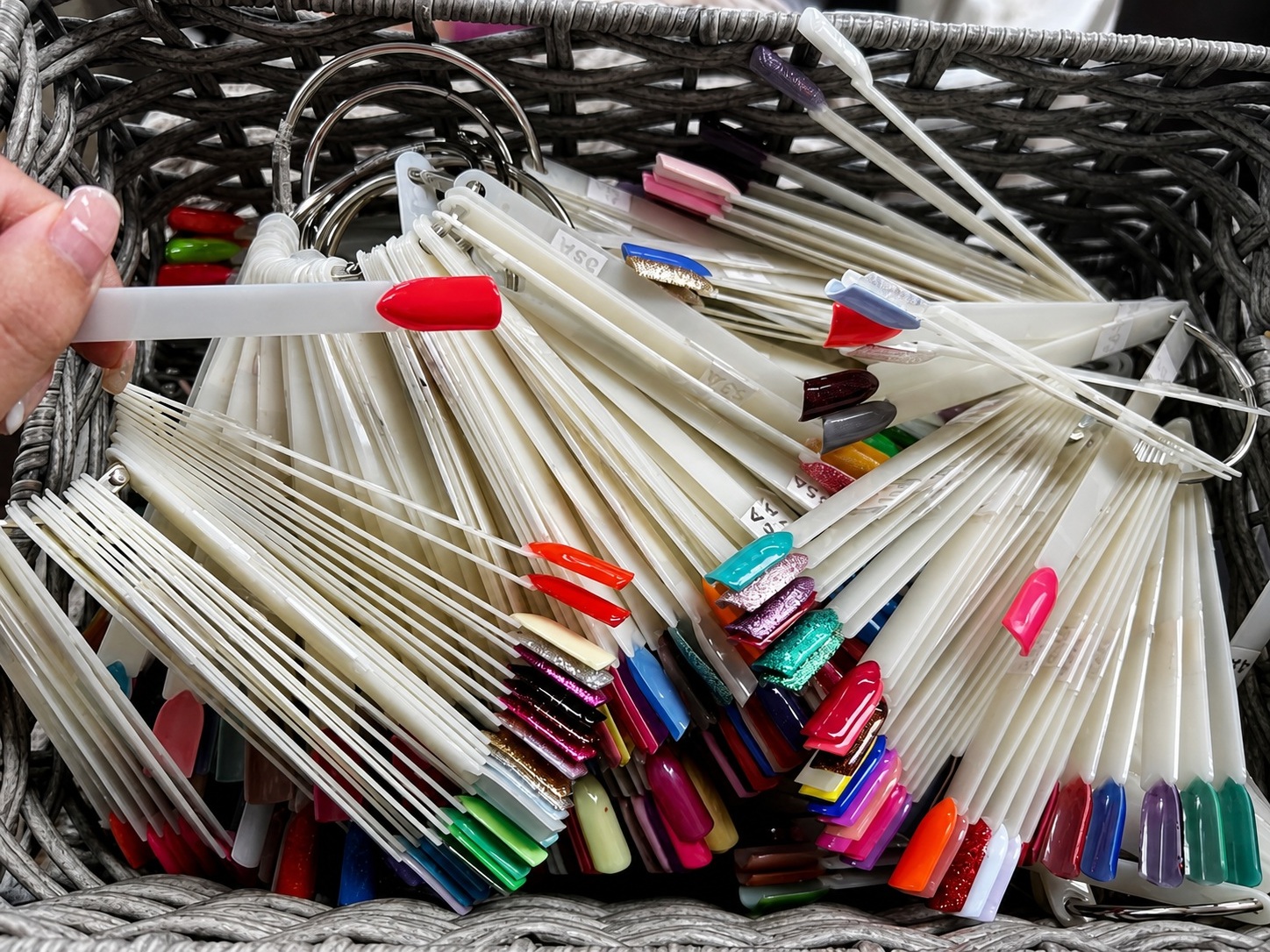 Nail color swatches displayed in a woven basket