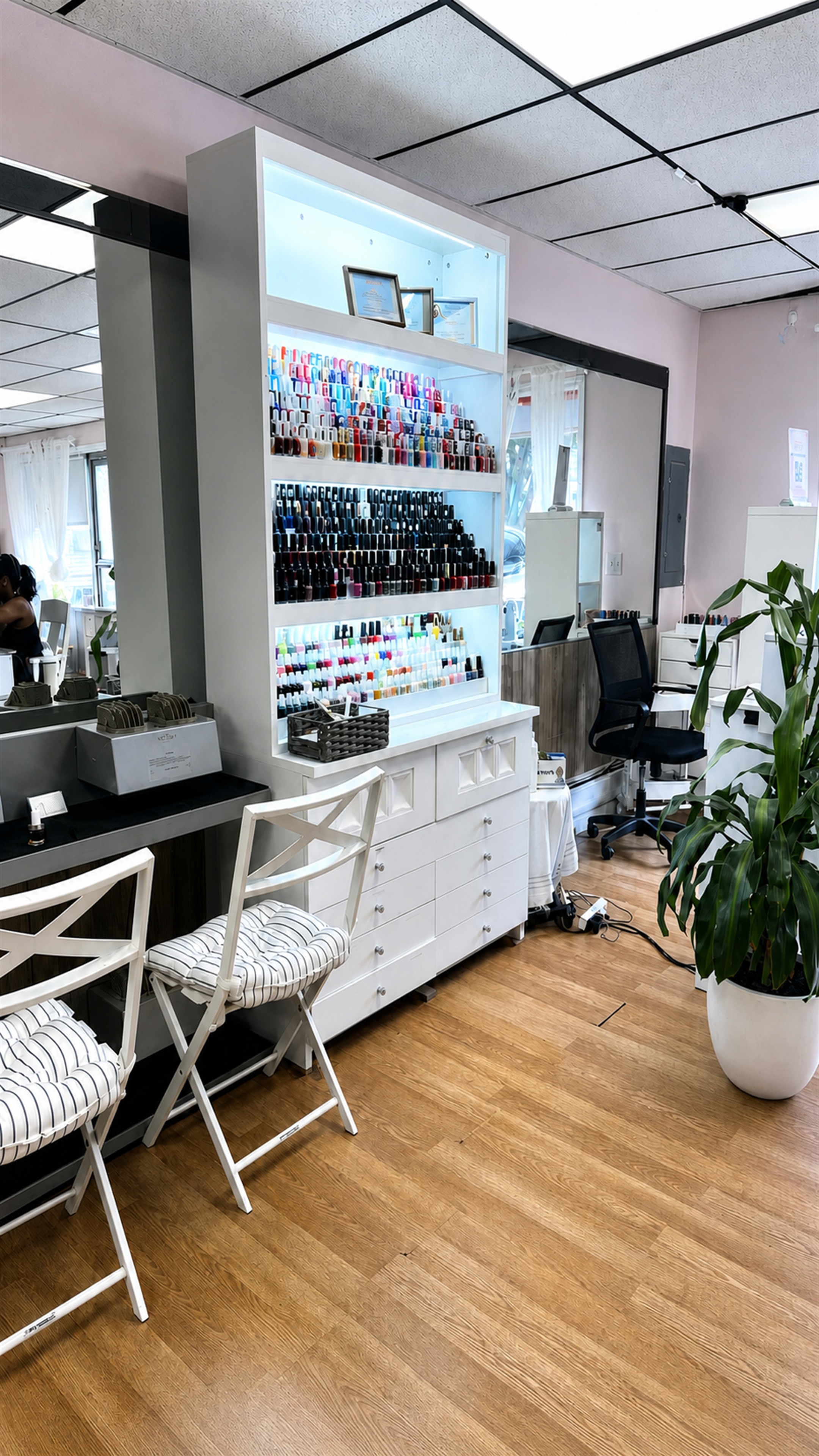 Interior of the Top Coat nail salon, with a polish display and manicure stations